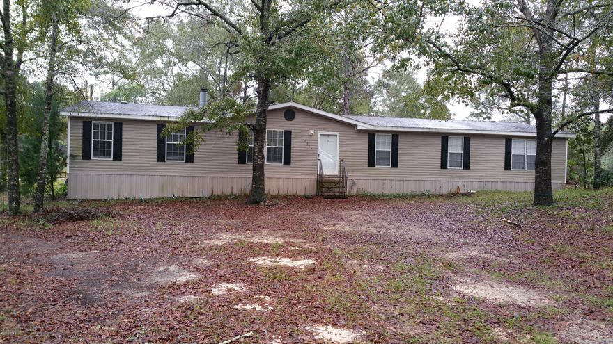 Huge 4Br/2Ba home! Plenty of room for the family in this double wide. All rooms are very large.  The Living Room features a stone, real wood burning fireplace.  The Master Suite has 2 Walk in closets! If you like to cook this kitchen is for you.  Large Island, Walk in Pantry, and a gas stove! This split floor plan features a built in desk in the oversized hall.  Perfect for a work area.  The home also features a massive game room equipped with a bar, sink, and cabinets.  All this situated on a 1/2 acre lot.  Hurry this one won' last long!