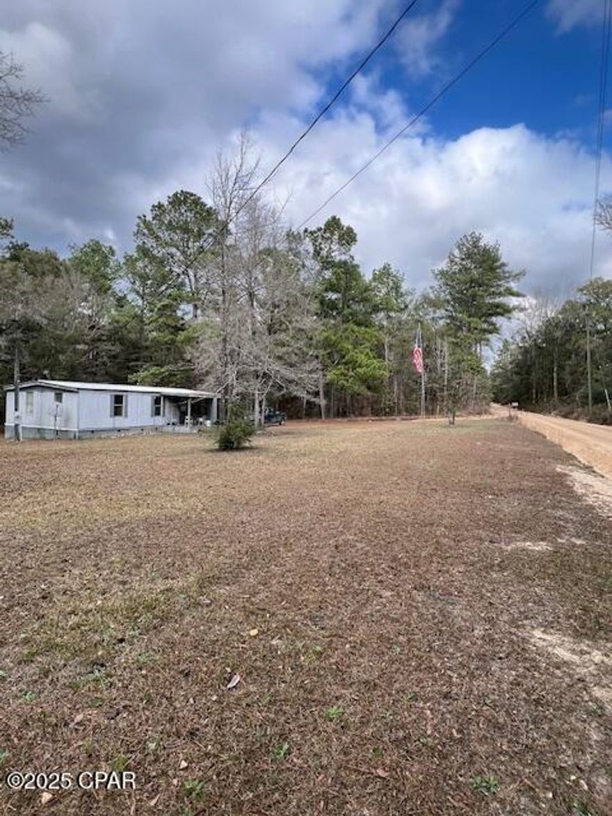 Tremendous opportunity for income producing properties ! Don't miss this one! Only 30 minutes to the beaches. Rental Income with 3 Mobile homes, 1 Doublewide with newly painted interior and flooring. Also 2 singlewides updated on two parcels totaling 4,5 acres with potential to add another unit. Located between Holmes creek and the River there are several county boat ramps close by. Three mobile homes on 4.5 acres on a well maintained county road and excellent rental history.