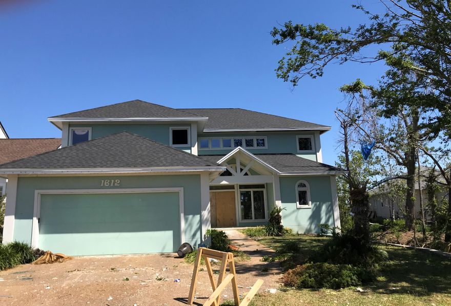 Bay front home located in Lynn Haven's Panama Country Club.  Home sustained hurricane damage.  New roof and interior tear out has been completed.  Home and lot have unlimited potential.  All ages, sizes and hurricane damage are approximate.