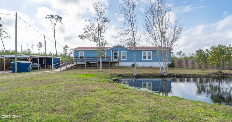 Currently under contract, seller excepting back up offer...
 A MUST SEE SCHEDULE APTOINTMENT TODAY! 
Spacious country living with over 2,000 square feet living space on over an acre, with your own nature filled pond. It's called a manufactured home; however it has the feel and durability of a custom built home, you will be very delighted you toured.  Featuring 3 Bedrooms & 3 Full Bathrooms plus a bonus room that could function as another bedroom or office, this home boasts a wide-open living space with new LVP floors & a wood-burning fireplace. There are two Master Suites, with large walk-in closets. The main Master Bath has a separate new tiled shower & soaking tub. Kitchen features all newer cabinets, new counter tops & appliances are lightly used. New A/C in July 2020 & Roof in December of 2018. Nice Pond out front & solid ramp and porch to the front entrance. Off the kitchen & laundry room is a new large wood deck for outdoor living and fenced in back yard for pets.  over 100k in upgrades from current owners: new spacious decking front and back, carport with attached workshop with 100-amp electricity, attic sprayed with insulation and powered solar fans to keep cool in the summer and warmer in the winter.  New vinyl siding and paint on exterior, completely newly painted on interior,  ALL new flooring, lighting and ceiling fans throughout.  This home boasts cleanliness and style.  A forever home they called it, so care and longevity was put into every detail.  You will want to call this beautful ranch style home yours.  Close to schools, some shopping, gas stations, and boat ramp within about 2.5 miles.