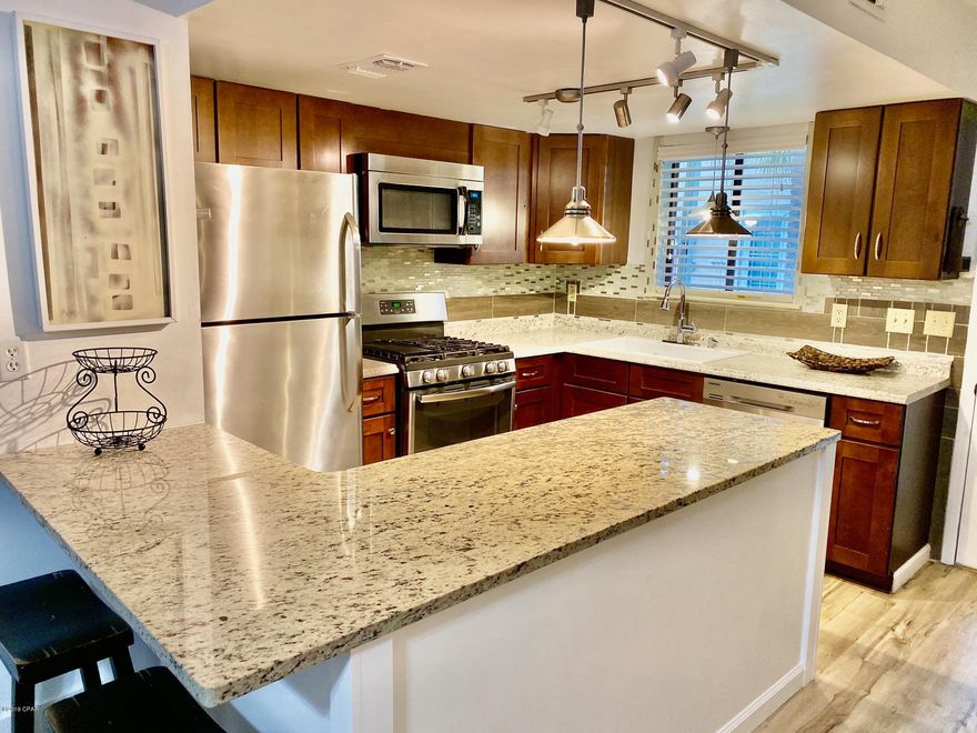 Many beautiful upgrades set this 2 bedroom unit apart.   New Roof in 2019.  New flooring throughout! 

Kitchen  recently remodeled, including cabinetry, counter tops, appliances, tile back splash, plumbing and lighting fixtures. Appliances replaced in 2018.   Perfect central location in the heart of Panama City Beach.  Top notch amenities include a Beach Front Pool and Recreation Building,  11 Swimming Pools (5 heated), Lighted Tennis Courts, Shuffle Board Courts, as well as kids play areas. The Complex is Golf Cart & Pet friendly.  Perfect for Short Term or Long Term Rentals .   Vacant and easy to see!