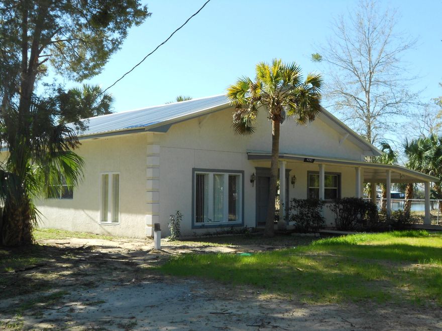 Motivated Seller-Make an Offer! Beautiful 1,962 square foot Home tucked away, in a quite secluded cove, on Deer Point Lake surrounded by other Beautiful Homes! New Metal Roof, Whole New Septic System, Wiring, Panel Box & Meter, Fresh New Carpet & Paint! Large, Open Floor Plan with a Full ''Wall View'' of Deer Point Lake & a Split Bedroom Floor Plan with 2 Water Heaters! Large Kitchen with Stainless Steel Appliances & an Island! There is a Stand Alone Bar in the Living Room, Too! The Master Bedroom has a very large Master Bathroom with a Dressing Area & a separate ''Powder Room''. There is a Large Laundry Room that can be used for various ideas, along with a 14'x25' Work Shop & a Carport! The Lake is Magnificent!