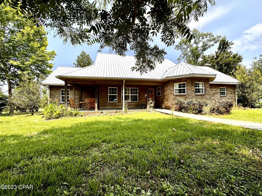 CURRENTLY UNDER CONTRACT, SELLER WILL CONSIDER BACKUP OFFERS.  Welcome to homestead paradise! Pictures will not do this place any justice. This 4/3 is nestled in on over 8 acres and surrounded by the most beautiful trees including fig, citrus, pecan, chestnut, and many more! There is plenty of cleared land for a garden, a HUGE chicken coup, a garage with storage, an in-ground pool, two large propane tanks for the gas appliances, and a recently serviced generator to power the home! Inside on the first floor you will find gorgeous hickory flooring and cathedral ceilings, a wood burning stove, your kitchen, four bedrooms, and three full bathrooms. Upstairs there are TWO bonus rooms that could easily be made bedrooms and an office. This home really has everything it takes to be self sufficient. Just take a look!