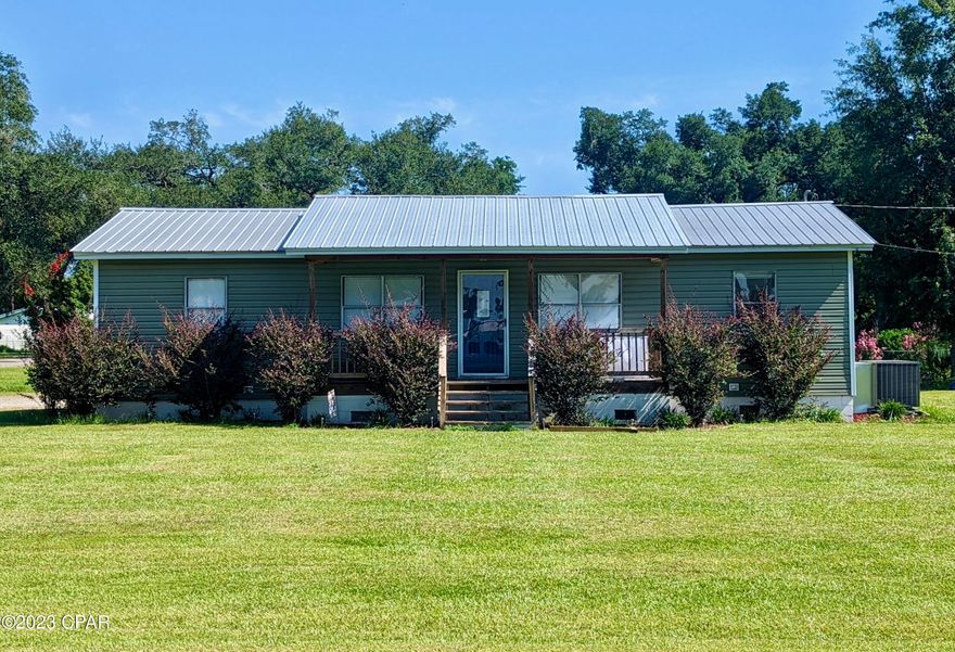 Quaint 3/2 on a large, in-town lot. Covered porch and deck, paved car pad and separate laundry/storage area. Landscaping and newer roof.