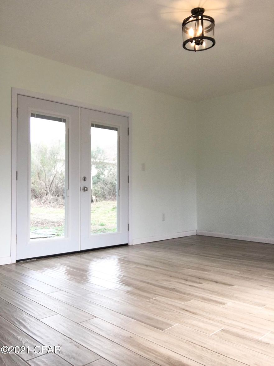 'CURRENTLY UNDER CONTRACT, SELLER ACCEPTING BACKUP OFFERS' Located in quiet, well maintained canal front community, this unique custom built chateau style home features a large great room on first floor with 20ft wall to ceiling windows and rustic stone fireplace.  Ceramic tile throughout kitchen, great room, dining room, downstairs bathroom and laundry room.  Dining room features two sets of French doors. One bedroom is located on first floor.  Upstairs you will find 2 more bedrooms, bathroom, and loft with walk in closet that can be used as fourth bedroom or study.  Attached one car garage features a sitting/bar area.  Above the garage upstairs bedroom features unique built in cabinetry and windows.  Lovely 1.1 acre lot with orange tree, holly, crepe myrtle, magnolia, and others.