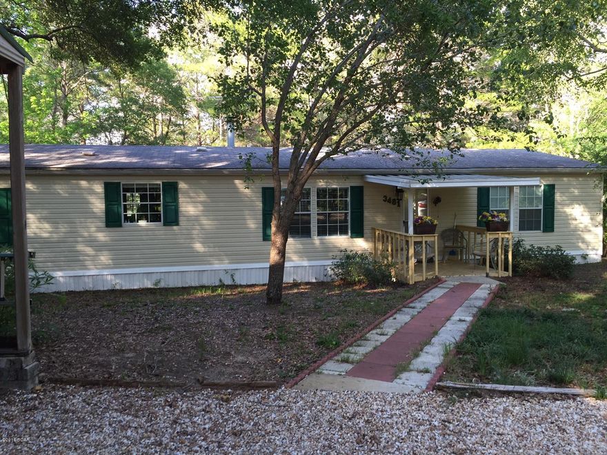 This is affordable waterfront living in the gated subdivision of Leisure Lakes. It has three bedrooms, two bathrooms with a split bedroom plan. The kitchen has a breakfast bar with plenty of cabinets, separate dining area, and a covered and screened deck off of the living room with a nice view of the lake and pier. There are plenty of trees and a few palm trees providing shade over the home. There is a storage building that also has a covered parking space. Also available to all residents of Leisure Lakes is a swimming pool, pavilion, boat launch, basketball court, tennis court, toddler playground and more. The security gated community has live guards during weekdays, and each resident has a private code to enter. More photos coming tomorrow.