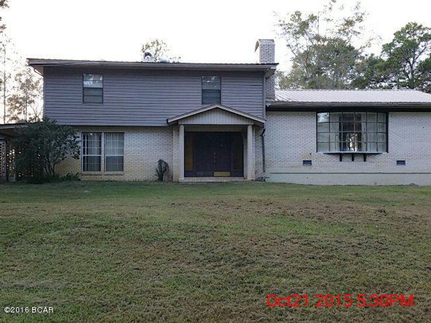 Large home on paved road just north of Bonifay, Florida and convenient to town.  This home is very roomy with a split-level floor plan.    Nice custom-designed kitchen has stove, dishwasher and refrigerator with ice maker.  Large amount of windows in kitchen provides a nice view of back yard.  Large den has a wood-burning fireplace.  All 3 bedrooms and 2 of the bathrooms are upstairs.  There is a small basement that houses the A/C unit and provides extra storage.  Sliding glass door leading from back of home onto a glass-enclosed sunroom.  Nice, big yard with plenty of room and home sits back from the highway.  Large barn with concrete floor behind home with two additional sheds behind barn.  This home needs some repairs as shown in photos but can be a perfect home for your family.
