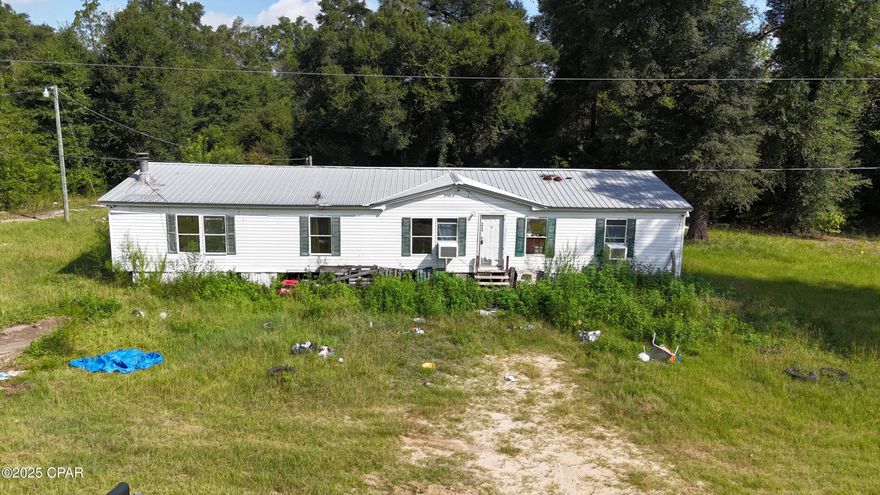This 1-acre lot in Bascom, Florida, featuring a 1998 double wide trailer, presents a fantastic opportunity for those seeking a project or a rental investment. With three bedrooms and two baths, it offers ample space for comfortable living. The paved road access enhances convenience and being just 1.5 hours from Panama City Beachâ€”famed for its stunning shoreline adds significant appeal. Plus, with Dothan Alabama only 40 minutes away, residents can enjoy a vibrant array of entertainment, dining, and shopping options, making this property a promising venture!