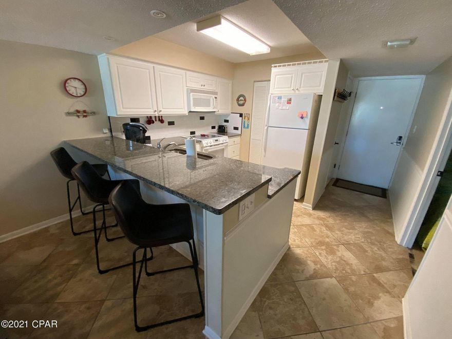 Spectacular view of the Gulf!  Updated kitchen and baths.  Recently installed new windows and sliding glass door.  Tile throughout.  Large balcony with lovely sunset views.  Recent new paint and ceiling fans. The Dunes of Panama is a Gulf Front Condominium Resort with 1,500 feet of private Gulf Front.  Three Gulf Front swimming pools, lighted tennis court, fitness room, shuffleboard, bbq grills, kiddie swings on beach, volleyball and much more.