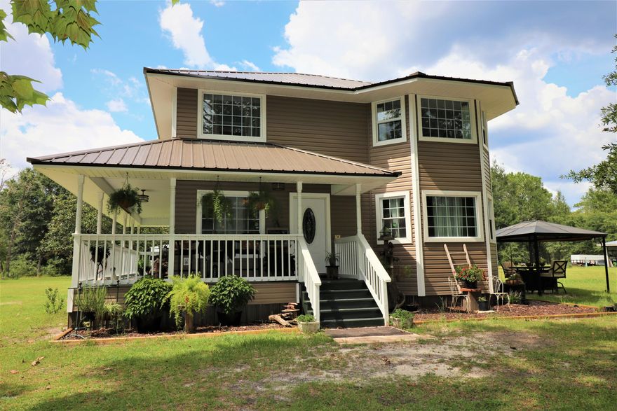 MINI FARM? GARDEN? HORSES/ CHICKENS? WOW, JUST WHAT YOU WANT!!! You'll love this charming 3/2.5, 2 story home on 3.68 acres completely fenced with a five-ft. chain link w/auto security gate. A large Oak tree shadows the wrap around porch on the front of the house that is perfect for watching the afternoon rain. Take a dip in the inground, salt water pool - energy efficient w/new Pentair and Polaris pumps. 24x40 concrete floored workshop/barn w/ electric. Pool house is 16x20 w/sunporch. This home was completely renovated 3 yrs. ago with all new appliances, heat pump, water resistant vinyl flooring, metal roof, vinyl siding, well pup and water treatment system. Country living at its BEST! Make your appointment today, this beauty won't last long!!