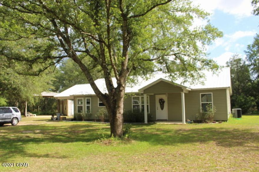 'CURRENTLY UNDER CONTRACT, SELLER ACCEPTING BACKUP OFFERS'  This seller is packing and getting ready for the new second homeowner to move in.  The seller continues to maintain the home which still has the newly built feeling.  Corner location that is completely fenced with two entrance gates on each road.  Many flowering bushes and plenty of oak trees shades the lot. Several water spigots thru out property.  450ft deep well. The 2 storage buildings, one with a connected pole barn will convey.  New metal roof in 2019. Yearly HVAC servicing and under a termite bond.  Split bedroom floor plan with an open living concept. Plenty of storage closets and cabinets, pantry, indoor laundry plus 2 attic access. Insulated walls & attic. The french doors in both the living room and master lead to more additional living areas in the oversized screened porches.