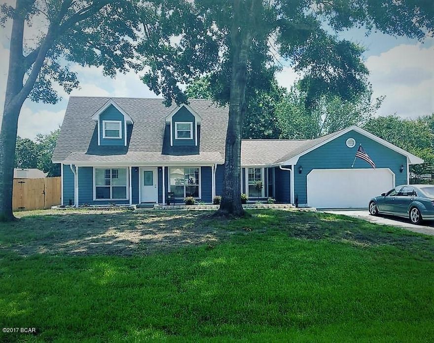 *price reduced* Beautiful Cape Cod style home in Lynn Haven for sale! Home features new paint, new carpet, all new doors through home, new stainless steel appliances w/ one year warranty, new custom bathroom in master bath. Tile in upstairs bathroom. Large laundry room with cabinets and sink. It has nice floating floors in living room and dining room. Gracing the windows are plantation shutters in living & dining rooms, and master bedroom. The light and airy sunroom has new wood tile that overlooks a huge backyard that has a brand new fence, and also has a chain link dog run along with a storage shed. This home has a lot of storage in both upstairs bedrooms. Attached 2 car garage. Large driveway with extra space to park boat or trailer. This lovely home is move in ready.