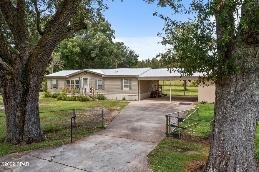 This spacious 3-bedroom, 2 bath mobile home located on a paved road would make the perfect starter home! Inside features include a split floor plan, open concept, large living room, eat-in kitchen, family room and spacious master suite with walk-in closet, soaking tub and separate shower. Outside you will find attached carport, fully fenced yard, covered back porch and attached storage room. Property is located directly off Old Bonifay Road minutes from schools, shopping and Hwy 77.