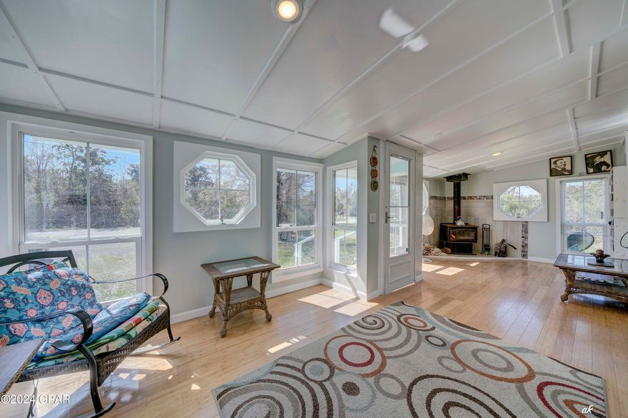 UNDER CONTRACT WITH CONTINGENCIES; SELLER ACCEPTING BACKUP OFFERS.
Possible developer opportunity.
County has approved putting three manufactured homes on the lot.  If the current residence is removed, 11 manufactured homes can be put on the lot.
The adjacent property owner collects $1600 per month on multiple manufactured homes, the possibilities are tremendous to make great rental income.
''The Mill Home'' is a historical landmark recently remodeled to include up-to-date modern finishes.  One of the most breathtaking features of the home is sunroom which graces the front of the home.   Located approximately 4.5 miles from Tyndall Air Force Base, this 1949 home has renovated for functional, modern living. Take a step inside this beautiful home to discover the perfect blend of classic character and contemporary comfort. Brand new 3/4 inch tongue and groove bamboo hardwood flooring was installed. New drywall, new paint, and newer double pane windows are throughout the home. 
The kitchen has newer cabinetry and a quartz countertop and an updated  backsplash has been recently installed, adding to the functionality of the home. The master bedroom has a walk-in closet, and additional storage.  Boasting two bedrooms and two bathrooms and 1,036 square feet of heated/cooled space, this home provides ample space for a growing family. The bathrooms have been upgraded with new marble countertops. Situated on a generous 1.119 acre parcel, this property has ample space for expansion.  In June 2023, the seller added a new HVAC unit installed by Pat Green Heating and Cooling.  The duct work is also new.  There is a warehouse and storage building in the backyard. Come make the ''The Mill Home'' your own special home.