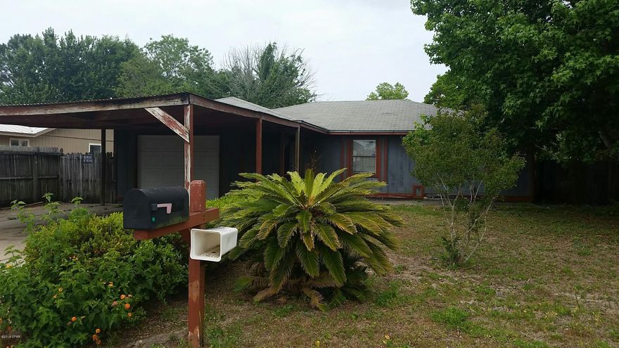 Great location for this 3BR/2BA home just a few blocks from the beach! The home needs some TLC, but it's situated on a big corner lot across the street from Hutchison Elementary School and a  church.  You're also convenient to Surfside Middle and Arnold High Schools, shopping centers and Pier Park!

The backyard is privacy fenced, there is a one car garage, and the sellers say the roof age is approx. 8-10 years old.  The home is being sold ''AS-IS''.  Fix it up and turn it into your dream beach cottage!  This is not in a flood zone, no HOA fees, and sewer hookup is available. All info is approx. and must be verified by Buyers if important.