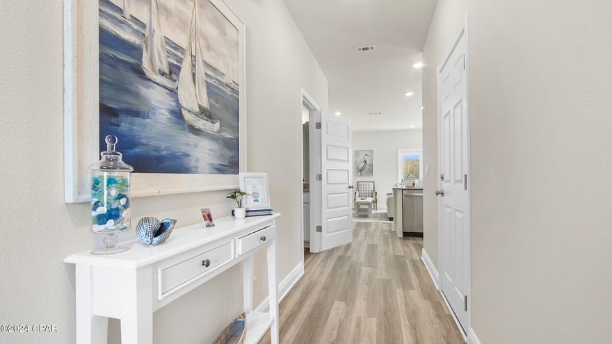 Welcome to Caballeros Estates at Hombre in stunning Panama City Beach. Live the Floridian life in style just a short walk away from white sandy beaches. This floorplan, The Palm, features 3 bedrooms, 2.5 bathrooms, and a 1-car garage with a widened driveway allowing 2 vehicles to fit side by side. All bedrooms are located on the second floor, leaving the first floor for entertainment and relaxation. The stunning kitchen is completed by Ivory painted Shaker Style cabinets, granite countertops, a center island with a single basin undermount sink, and Whirlpool kitchen appliances which include a stove, microwave, and dishwasher.