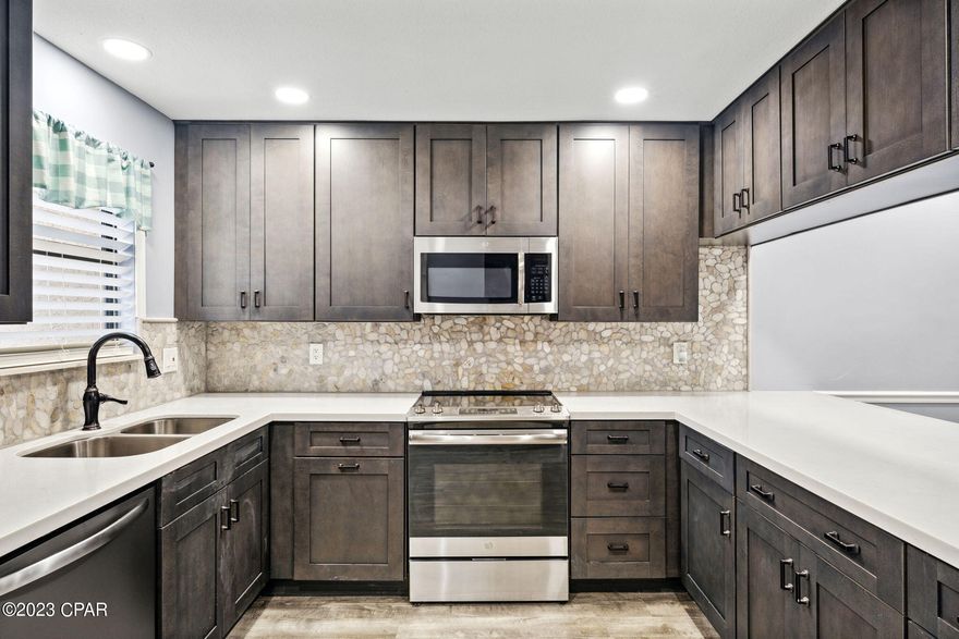 CURRENTLY UNDER CONTRACT, SELLER WILL CONSIDER BACKUP OFFERS This is a Rare Find Fully Updated, Fully Furnished, Ready to be enjoyed and bring lots of passive income. You will be amazed by the style, location, privacy and the island feel of this unique end unit with an attached garage for your golf cart, motorcycle or storage. All new High End kitchen cabinets, quartz countertops, SS appliances, LVP flooring downstairs, backsplash, custom bookcases with fireplace, custom bar etc. Brand new metal roof in 2019 and new hurricane rated windows. Extra parking space for at least 3 cars + the garage. A short 4 min walk to the beach. It backs out to the largest community pool with a beautiful extended back patio where you can enjoy the evenings and Florida nature.  STR allowed with projected ROI of 60k+! All info is believed to be correct but all parties must do their due diligence. HOA includes: 11 pools(5 heated) shuffleboards, beach house/café, mini golf, tennis courts, exercise room, WIFI, cable, pest control, termite bond, trash, ground keeping, property patrol, gated community etc.