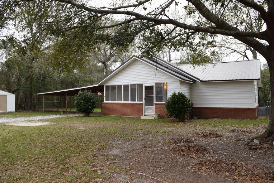 Country cottage sits on over an acre updated and cute. The yard is fenced, there is three car carport plus two yard buildings. The kitchen is new has decorative backsplash, floors are wood and the kitchen is wide open to the living room. The air conditioning system is new as is the flooring in most areas. The appliances are all stainless steel and new. Come see this southern charmer.