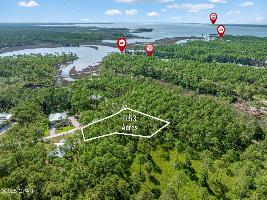 Build your dream home on this beautiful ½-acre wooded lot, tucked away on a quiet cul-de-sac on Deepwater Creek Lane in the highly sought-after gated community of RiverCamps.

This spacious homesite offers a large buildable area, surrounded by natural beauty and privacy. RiverCamps is a 1,500-acre waterfront preserve where fewer than 450 homesites will be developed on 500 acres, with the remaining 1,000 acres protected for conservation. Located just 9 miles from the sugar-white beaches and 10 minutes from the Northwest Florida Beaches International Airport, RiverCamps offers the perfect blend of seclusion and convenience.

Community amenities include nearly 7 miles of scenic trails for hiking, biking, or golf cart rides, along with day-use boat slips, dry boat storage, and a private boat ramp giving you access to Shell Island and St. Andrews Pass in just 30 minutes.  Residents also enjoy use of kayaks, canoes, paddleboards and pickleball courts.  After a day on the water, relax at the community's zero-entry pool or  bonfire area.