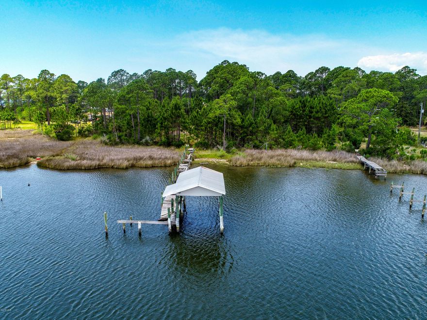 Incredible opportunity to own 1 acre of property on Doty's Bayou. Protected tected deep water bayou with intercoastal waterway access. Property includes circle drive, old Dock that will need repairs. Located in fast growing area of Bay County. New developments all around this property- such as Bridge Harbor. Potential for individual homesites, townhomes. Beautiful deep water only minutes from the intercoastal and approximately 20 minutes from the pass to the Gulf of Mexico. Zoned high density residential- 1515 Doty Circle also available.