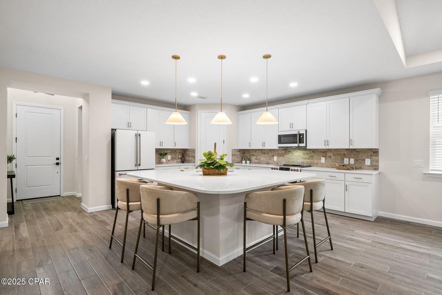 INCREDIBLE PRICE IMPROVEMENT! THIS HOME IS STUNNING! 

Latitude Margaritaville Watersound, a beautiful 55+ community, perched along the Intracoastal Waterway. 

Stunning Seashell Bay (formerly the Hammock Bay) floorplan located in the highly sought-after Phase 5, offering both privacy and serenity on a lush preserve lot. Furniture available for purchase outside of contract (all furniture, including high-end pieces Solana Dining Chairs/Rove Concepts) and so much more! This beautifully appointed home features an open-concept design with soaring cathedral ceilings, a great room with gas fireplace, and a wall of sliders opening to the extended screened lanai--perfect for seamless indoor-outdoor living.

The chef's kitchen showcases high-end GE Café appliances (double oven, microwave, and refrigerator--installed post-closing at approx. $8K), quartz countertops, tile backsplash, upgraded 42'' soft-close cabinetry with pull-outs, designer hardware and faucet, and a large island with custom lighting. The spacious dining area flows beautifully for entertaining.

The primary suite offers bayed windows with peaceful preserve views, a luxurious ensuite bath has a tile shower with a frameless glass enclosure, upgraded cabinetry and fixtures, and dual walk-in closets ready for customization. The secondary bedroom is conveniently adjacent to a full bath, while a dedicated study/office with French doors provides the perfect flex space.

Additional upgrades include tile flooring throughout, designer paint, recessed lighting, blinds on every window, and a garage featuring an epoxy floor, utility sink, and pull-down attic stairs for extra storage. Exterior highlights include hurricane shutters, and an extended screened lanai with coated flooring overlooking the spacious, private backyard.

Perfect primary, second home or investment property ready for immediate move-in. 

Living in Latitude Margaritaville Watersound means embracing a true resort-style, active adult 55+ community, coastal lifestyle designed for fun and relaxation. At the heart of it all is the Town Square where live entertainment fills the air on a daily basis and every Fri/Sat. night! Homeowners enjoy the Resort-style pools- perfect for lounging in the Florida sunshine or enjoying a swim with friends. State-of-the-art fitness center & group classes - including yoga, spin classes and lap pool and spa, water aerobics to name a few. Walking, biking, and golf cart trails that wind through the community with easy access to all amenities and a underpasses for safe and convenient access throughout the neighborhood. Sports courts - including pickleball, tennis, and bocce, basketball encouraging friendly competition and active living. Kayak launch for adventure seekers, Last Mango Theater for shows and events, ceramics and wood working shops, pet grooming and a dedicated dog park. Beyond the amenities, Latitude Margaritaville Watersound offers a low-maintenance lifestyle--with lawn care included in HOA dues, a 2/10 structural warranty, giving residents more time to enjoy the beach, boating, or exploring nearby Panama City Beach and 30A. 

A future shopping complex to include a Publix grocery store, dining and shopping options and a public marina is planned on site. New hospital currently being built 5 miles from the community. Whether it's a sunset golf cart ride, cocktails by the pool, or mingling with neighbors at one of the many social groups, this is a place where every day feels like a vacation. This home is more than just a showcase of luxury and upgrades--it's a gateway to the Latitude Margaritaville lifestyle. 

This beautifully upgraded and meticulously maintained home in a prime LMWS location is ready for you to move in and enjoy the Latitude lifestyle!