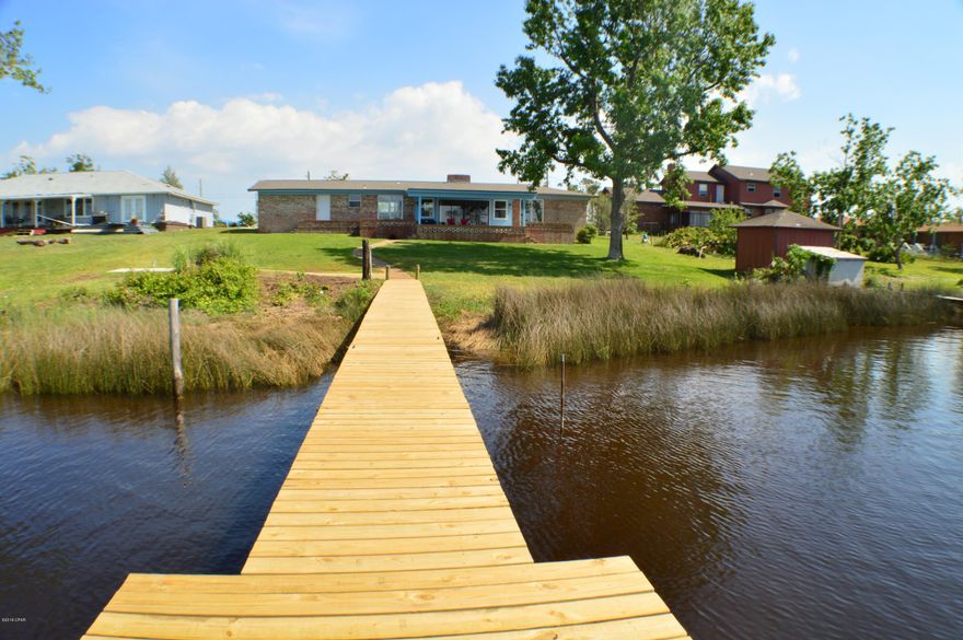 CURRENTLY UNDER CONTRACT, SELLER ACCEPTING BACKUP OFFERS.Gorgeous waterfront home in Callaway Shores now available!  This 3BR/2BA home has been completely repaired w/a brand new roof, windows, doors, flooring, & garage door within the last 2c months.  The home is spotless & you'll love the open-floor concept & all the sliding glass doors offering panoramic views of the bayou & beautiful backyard.  Even the dock is brand new & has power & water.  This deep-water bayou can accommodate deep-draft vessels (you'll notice all the big sailboats at neighboring properties).   And you're right at the entry to Callaway Bayou!  There is a slab where you can put a shed/workshop & power is available.  The Kitchen was remodeled in 2017 & appliances are stainless.  There are two open patios dining area and the other off the Master Bedroom and there is a  large covered patio off the living room.  Additionally, the home has a 350' private well and is on public sewer.  This is a move-in ready waterfront delight and if you are a nature lover, this is the home for you!  All info is approx. and must be verified by Buyers if important.