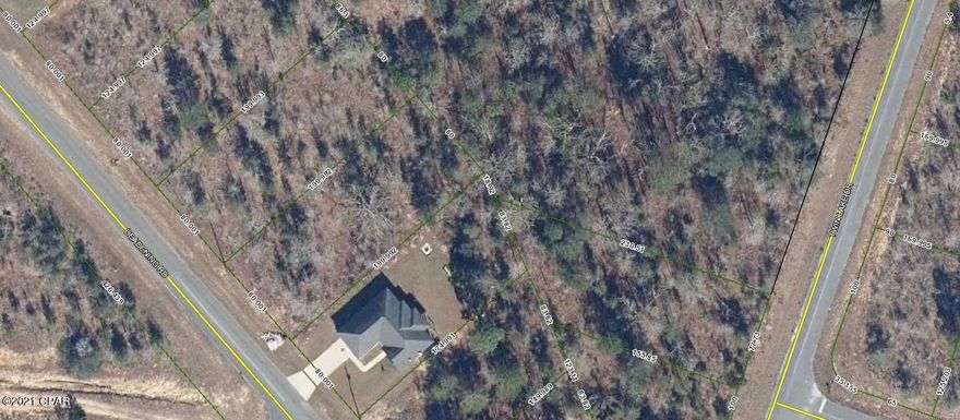 Pretty building lot that is lightly wooded and appears level on a paved road..  There are restrictions against mobile homes.  Quiet area away from heavy traffic.  There are many lakes for fishing and the NWFL International Beaches Airport is approx 20 miles and the beaches are approx 30-40 miles. The Buyer will pay Title Policy, Search Fee, 1/2 Closing Fee and Recording of Deed.