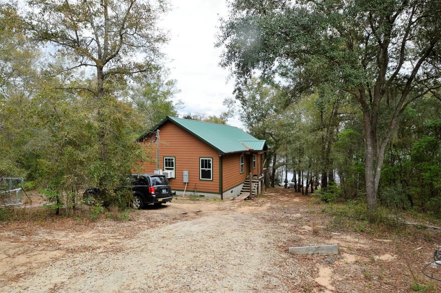 Waterfront on McDaniel Lake!!!! Gasoline engines allowed. Cozy Cabin, ready for finishing touches... Custom built cabin with large covered porch with view of water. Home needs a few finishes before final permitting. Gated privacy off road..a must see.
