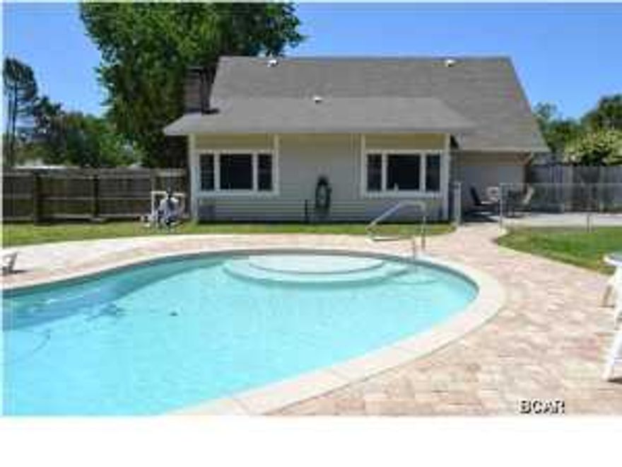 MOVE IN READY HOME NEAR THE BEACH - SALTWATER POOL!!! The interior of this home features 3 large bedrooms, 2 full bathrooms, 2 stories (master bedroom on the 1st floor), 2 living areas, 2 dining areas and a heated and cooled garage/rec room/laundry. The kitchen has been remodeled to include solid surface countertops with built-in dish drain and pot holder, a breakfast bar, a built-in wine rack, custom hardwood cabinets and a Chicago brick back splash and wall. All major appliances convey. The flooring on the first floor is an attractive hand scraped laminate. The back room features the dining/living room with wood burning fireplace. This room is surrounded by hurricane rated windows and overlooks the backyard. The 2nd floor has 2 good size bedrooms and a hall bath. There is ample