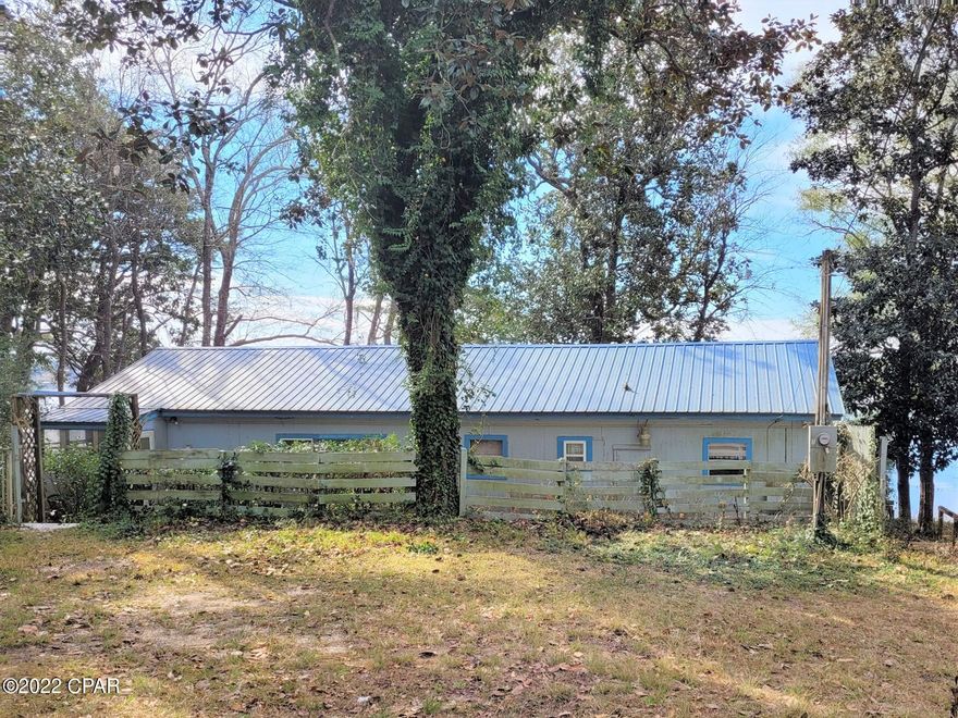 SUNSET VIEWS on almost one acre (0.93/acre) of WATERFRONT PROPERTY on Lake Juniper.  3-Bedroom, 2-Bath singlewide mobile home with a living room and a large sunroom, both with amazing views of the lake. Home needs some upgrades and cleaning but has great potential. The existing mobile home could be upgraded or replaced, or you could build your dream home here. Has 2 boathouses with fishing docks and a separate boat house with a wench to store your boat in.  Property is partially fenced and has a large workshop with room to store an RV. Circle drive leads from paved road to the home. Lake Juniper is a state-managed 665 acre lake with catfish, bass, and bream. Buyer to verify all measurements and dimensions.