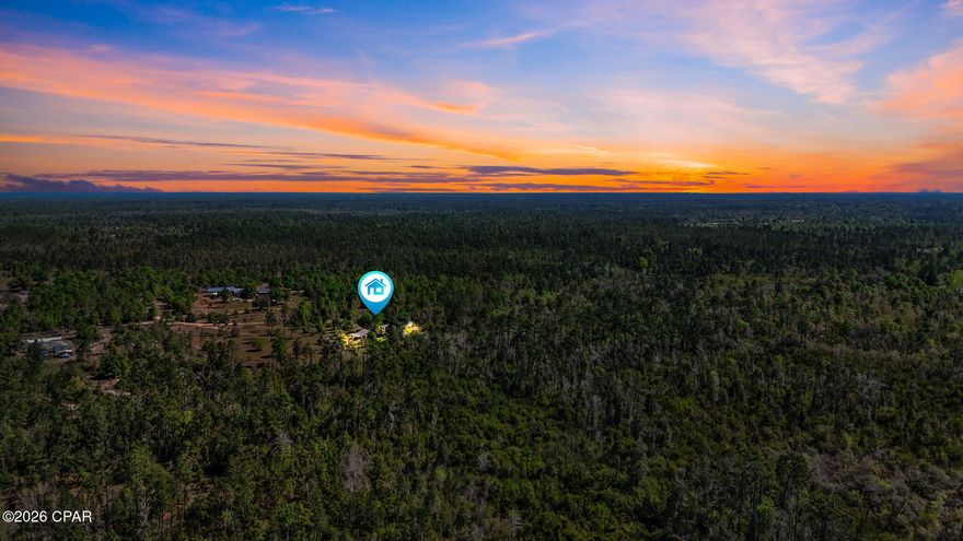 Welcome to a private 10 acre homestead opportunity in the heart of Florida's peaceful countryside. This versatile property features a cleared 5 acre field with established citrus trees, berries, and grapes, plus ample space for additional cultivation, livestock, and horses. You will love this quiet, natural setting where deer and native wildlife frequent. The 2 bedroom, 2 bathroom mobile home has been taken down to the studs; most insulation, plumbing, windows, and dry wall have been replaced, ready for your finishing touches. Systems are all functional.
Additional features include a large workshop equipped with power and water, a fully fenced perimeter, and a secure gated entrance. There is great potential here for a private retreat, family farm, retirement home, or investment property.