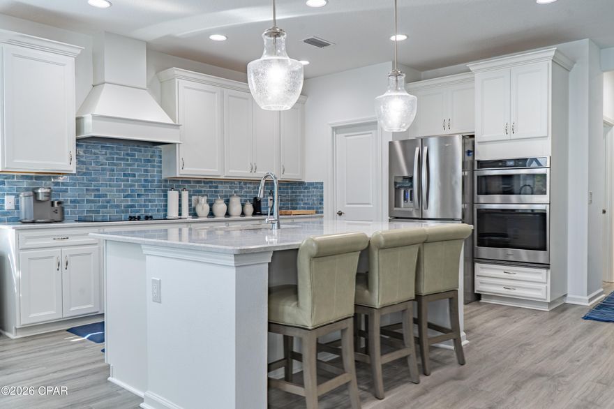 Welcome to this exceptional Trinidad Bay home in sought-after Phase 4 of Latitude Margaritaville Watersound, ideally situated on a beautiful private preserve lot along a quiet street comprised exclusively of Island Collection homes. This stunning residence offers thoughtfully designed spaces, extensive post-closing upgrades, and effortless indoor-outdoor living.

Step inside through a soaring two-story foyer highlighted by a custom coastal-inspired feature wall that sets the tone for the elegant finishes found throughout the home.

The heart of the home is the gourmet kitchen, designed for both everyday living and entertaining, featuring upgraded cabinetry, quartz countertops, custom tile backsplash, designer range hood, wall oven and microwave, and an oversized island perfect for gatherings.

The open concept layout flows seamlessly into a spacious dining room with a striking electric fireplace and custom accent wall, while the expansive living room boasts soaring cathedral ceilings and a dramatic wall of sliding glass doors that connect the interior to the outdoor living space.

A private den/office offers additional versatility and features a custom built-in bar with cabinetry and wine cooler, perfect for entertaining guests.

The luxurious primary suite offers a relaxing retreat with a spa-inspired bath and custom closets, while two additional guest bedrooms each feature their own en-suite baths, providing comfort and privacy for visitors.

The custom-designed laundry room is truly exceptional, featuring abundant cabinetry, a laundry sink, a built-in butler's pantry, and an additional refrigerator.

Enjoy Florida living on the extended screened lanai overlooking the peaceful preserve, the perfect setting for sunset views and evening cocktails. Outdoor furniture may convey with an acceptable offer.

Additional highlights include:

• 3-car garage with high-quality workshop

• RevWood by Mohawk laminate flooring throughout main living areas

• Casablanca ceiling fans and designer lighting throughout

• Electronic remote shades

• Custom feature walls in foyer and dining room

• Higher-level and custom cabinetry throughout the home

Many of these impressive upgrades were completed after closing, creating a home that feels truly one-of-a-kind. The property is priced below recent appraised value, presenting an incredible opportunity.

Located in the award-winning Latitude Margaritaville Watersound, residents enjoy world-class amenities including a private restaurant and bar, resort-style Paradise Pool, state-of-the-art Latitude Town Center, fitness center, pickleball and tennis courts, Barkaritaville Dog Park, live entertainment at the Bandshell, theater, wood-working shop, ceramics studio, walking and biking trails, and a full calendar of concerts, events, and social clubs.

Exciting growth continues nearby with a new hospital under construction and future commercial development including a Publix grocery store and additional shopping and dining options.

And best of all, the white sugar-sand beaches of the Gulf are just 7 miles away.

Experience the best of coastal resort living in Latitude Margaritaville Watersound, where every day feels like a vacation.