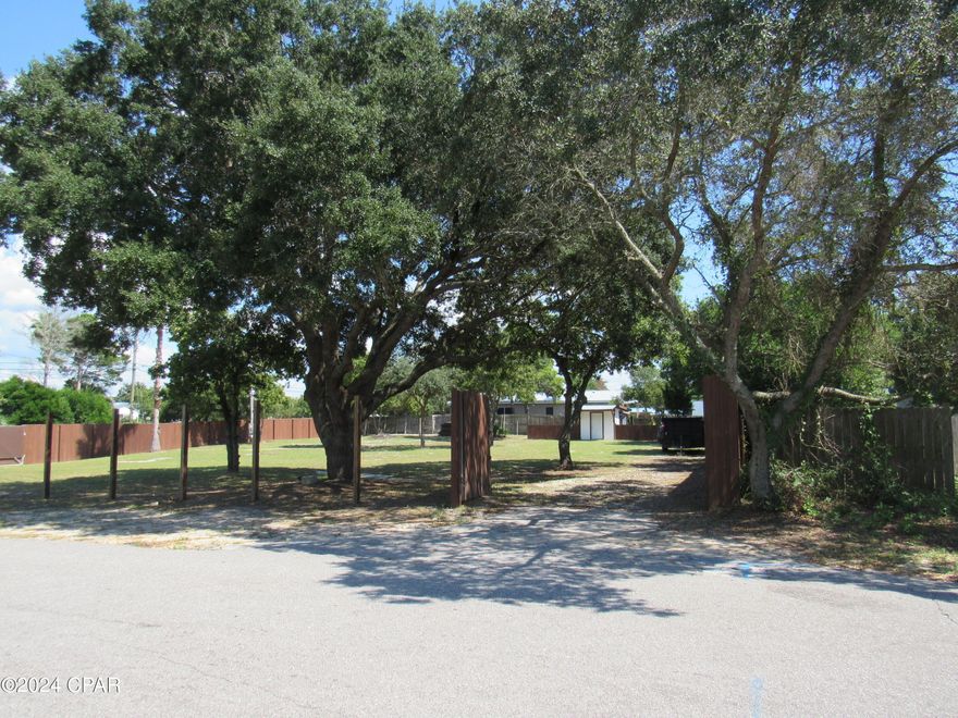 Gorgeous trees adorn this cleared, shady lot on the desirable West End of Panama City Beach! Very popular area, close to shopping, restaurants, and more. Nice and peaceful, just a short ride from Pier Park and the white sands of the Gulf of Mexico! This partially fenced lot is just waiting for you to build your dream home with water, electric, and septic on site. Owner states that it is zoned for two homes but if rezoned, it could have four homes. Don't miss this amazing opportunity! Please verify all measurements and information.