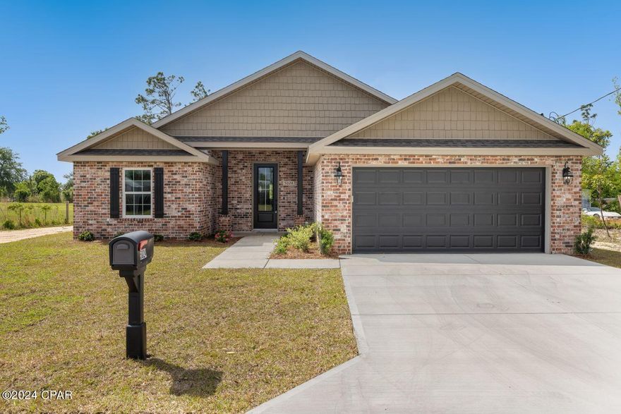 Reward yourself with this new construction home with brick finishes. This 4 bedroom, 2 bathroom home boasts 1,668 Sq Ft of heated and cooled living space. Adorned with a brick front exterior,Rain gutters, a new privacy fence, a 2 car garage, Luxury vinyl flooring throughout the living areas, a covered front porch, tasteful finishes, and tray ceilings in the master bedroom and the living room. The spacious open kitchen features granite countertops, matt black stainless steel appliances, a pantry, and a breakfast bar, ideal for culinary adventures and entertaining guests. This split floor plan offers a large master bedroom and a master bathroom with his and her closets, double vanity, a walk-in shower, and a large soaking tub. The additional 3 bedrooms provide plenty of space for family and guests. Other highlights include a large third of an acre lot, 10' ceilings with 12' tray ceilings in the living room, bluetooth garage lights, foam insulation in the walls and roof, wifi smart thermostat, a ring doorbell, and a large laundry room for added convenience. This homes location is convenient to grocery stores, schools, dining and Tyndall Air Force Base. This beautiful home truly is a must see! Call today to schedule your private showing.