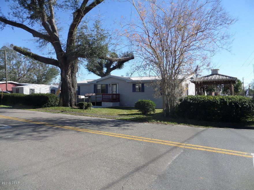Back on the market  .For Cash Only!!!!!!  It is ready to move in.  The home is well kept. Owner states no hurricane damage to home.   Nice sun porch out back, exit doors from living room and utility room. Front has nice shade tree with a gazebo, you can see lake as you enjoy the swing,  handicap ramp to enter.  There is a nice storage building and a work shop.  Please measure for exact measurements.