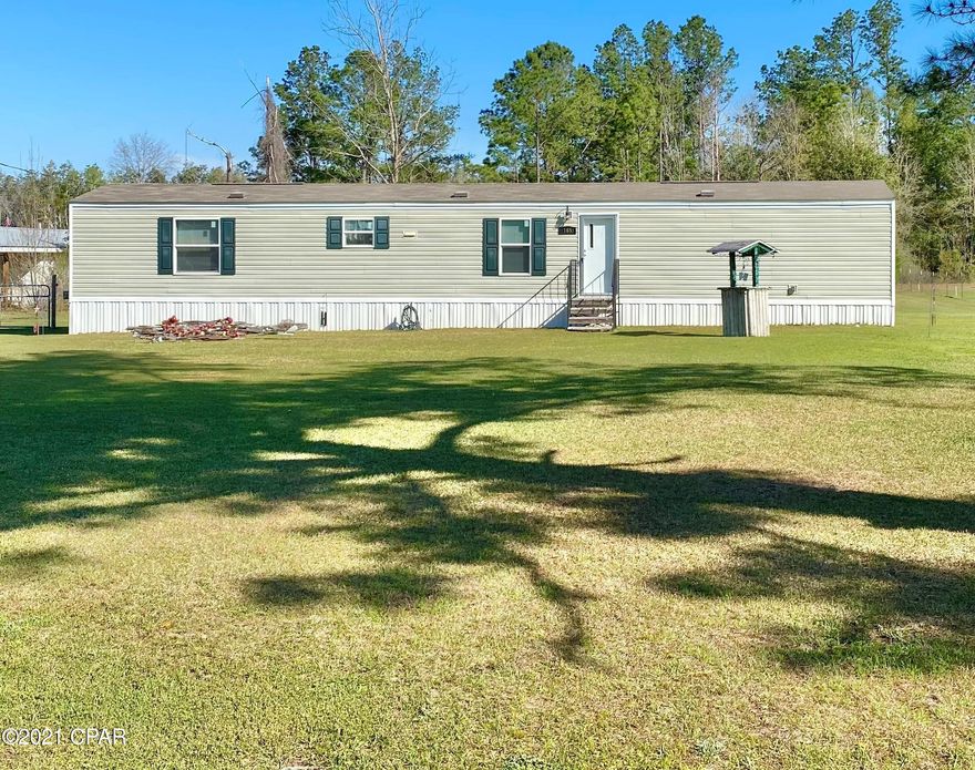 Newer single wide mobile home in the city limits of Wewa, minutes away from Dead Lakes, the Chipola River, Apalachicola River, and only 9 blocks away from the Land Lake landing. This zone 4 home was placed here new in 2018, a few months before Hurricane Michael and sustained no damage. Inside there are 3 bedrooms and 2 baths, along with an inside laundry area. The kitchen features an upgraded Kenmore Elite stove and dishwasher. On the back of the home there is a deck overlooking the spacious back yard. In the back yard there is a storage shed with an attached carport, above ground pool, and is completely fenced in with gated access. Here you will be minutes away from many lakes/rivers for great boating/fishing and about a half an hour from Mexico Beach and Port Saint Joe! NO flood zone