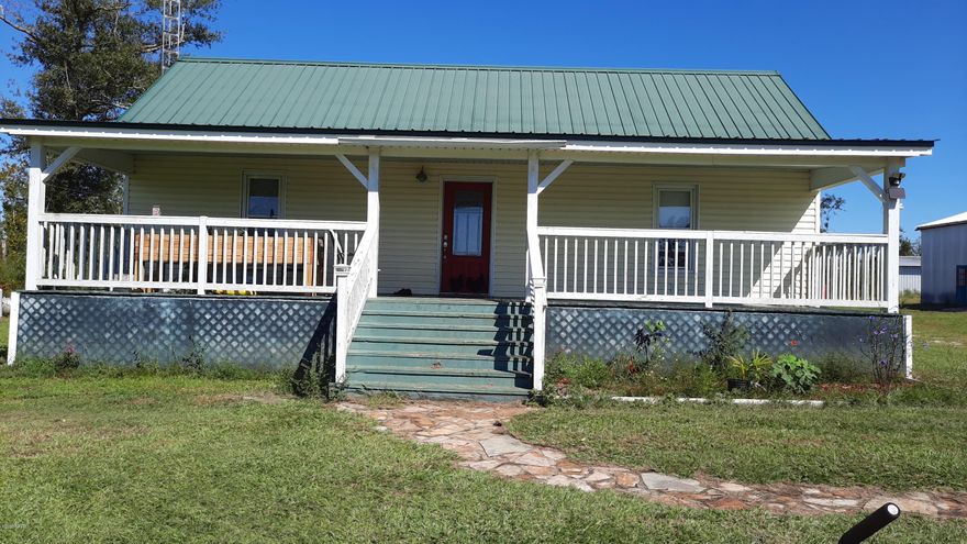 BRING YOUR HORSES to this updated 2 Bedrooms 2 Baths Country Home on 4.9 partially fenced acres 3 Barns, one with 2 stalls. Needs back part of roof replaced. Electric and water to 2 of them. New Septic Tank and Drain Lines in July . Chicken House that needs TLC. Enjoy fresh eggs every day. Front porch, the width of the house, plus back Sun Room to sit and watch your horses running while drinking sweet tea. New Roof in 2010 Spacious Bedrooms and Baths with wood floors. Vinyl flooring in Kitchen. Kitchen with two Dishwashers and plenty of cabinets.  If you want country living, but can be at Walmart with in 15 minutes, this is the place for you. 10 Minutes from I-10