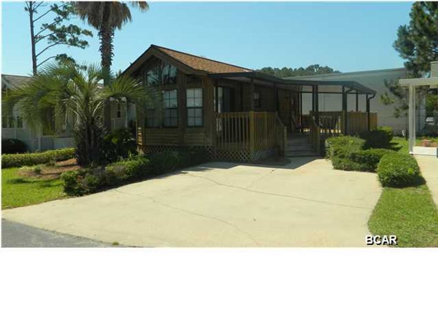 Your very own cabin by the sea awaits in this immaculate Emerald Pointe home. This one bedroom, one bathroom unit offers a few extras including a huge wrap-around deck partially covered, a dishwasher and washer/dryer. The home is being offered fully furnished and has excellent rental history for those looking for investment. All appliances convey. It has tons of built-in storage space and plenty of room for an addition if desired. This is truly a one-of-a-kind in Emerald Pointe.