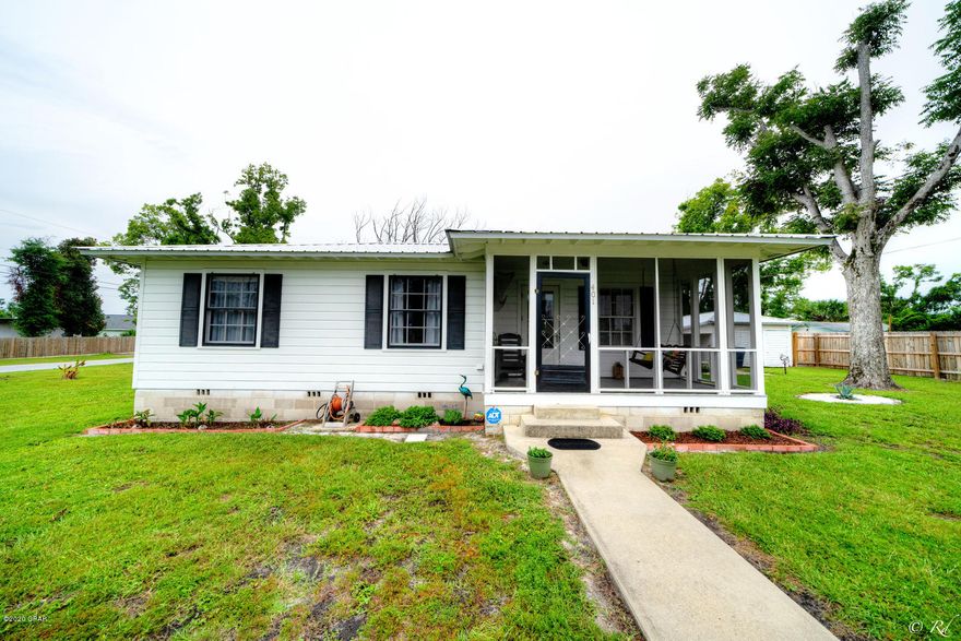 Well kept 3bd/1bth home on large double corner lot. 3rd bedroom is currently functioning as a laundry room. Wood flooring throughout and tile flooring in the living room complete with wood burning fire place. Kitchen has a breakfast bar. Cast Iron pipes removed and complete new plumbing installed throughout the home in March 2020. Electrical wiring system updated in 2020. 2 year old metal roof. Home has alarm system also wired to the workshop. RV outlet connection, Orchard, detached workshop, screened in front porch,. A gas generator, Riding lawn mower, roll away work bench, grinder and some tools and glass patio dining table all convey with the home.. Completed with a crushed cement parking pad. This home is move in ready.