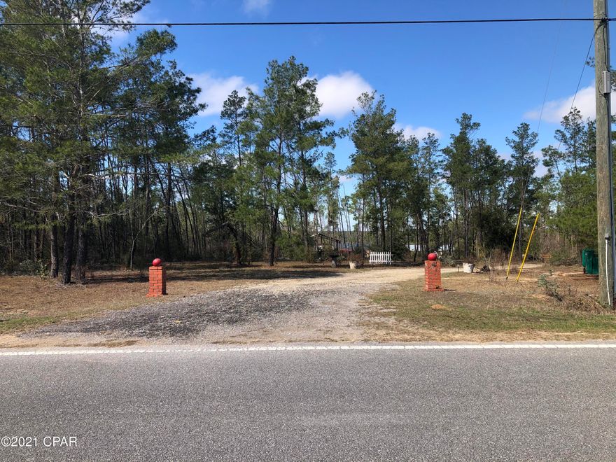This is a beautiful property just north of Bay County line off Hwy 77 on a paved road called  Rolling Pines Rd. The 6+ acres is on the lake approximately 81 feet of lake front  62 feet on Rolling Pines, 172.6 feet on Travis Trail.  The property runs just short of 1265 feet deep on the South property line and just short of 1842 feet deep on the Northern property line.  Most of the property is cleared with lake views from 2 of the 3 bedrooms and the main living/dining/kitchen area.  The mobile home is a 2018 , 3/2 approx. 1296 sqft.  2 Pole Barns, and Storage Building.   Power Lines underground. Very well kept property.  You will not want to miss this property. Across the street is NWFL Water Management District.  Schedule your appointment today.