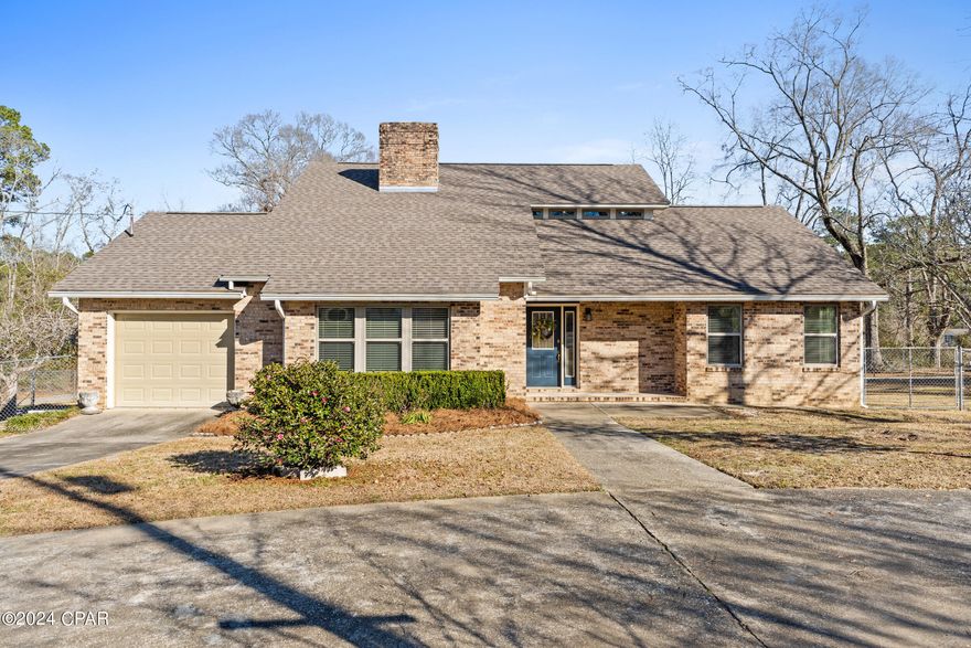 Welcome home! Such a sweet aura awaits you!  In the heart of the city, sits a charming, brick, 1.5 story home with a full acre yard showcasing mature landscaping and a semi-circle paved driveway. This 3 bedroom/2.5 bath home with one-car garage is suitable for anyone from a growing family to empty nesters, as the master bedroom is quietly tucked away on the main floor while the two other bedrooms with a full bathroom & study/lounge area await upstairs. The living room is situated at the front of the home where it is emits a welcoming air and boasts a fireplace. The kitchen has a formal dining area on one side and a breakfast nook on the other and has plenty of cabinet/storage space. Right off of the dining area, the living space extends into a 9x26 enclosed veranda with a panoramic view of the back yard. Part of the huge back yard is fenced with chainlink and the remainder of the yard is open for expansion opportunities if desired. There is also a 450 sq. ft. detached garage with a concrete floor & double swinging doors for parking utility vehicles or equipment. This home is just waiting to be transformed by your own vision and personal decor!