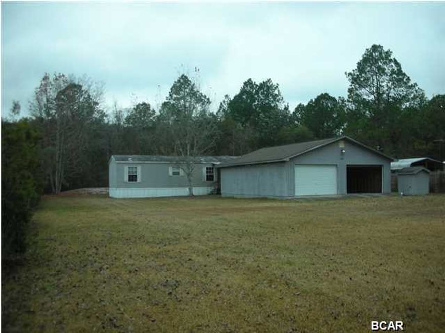 Howard Creek. Well maintained 2BR/2B Mobile Home on fenced half acre lot. Also a 30' x 36' garage with concrete floor, work bench, etc. Septic and Well with Culligan System. ''AS IS''