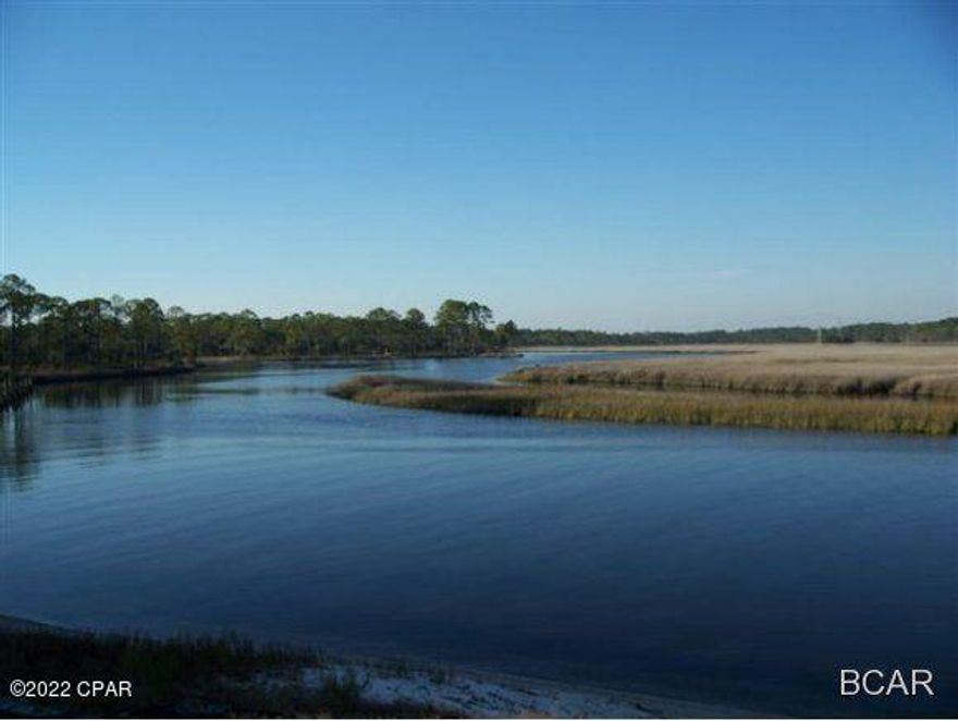 Premium homesite with great view  of West Bay! No Build Out time and just a short drive to the airport, Pier Park and the West end of Panama City Beach. Rivercamps on Crooked Creek is a coastal sanctuary on the waters of Crooked Creek , West Bay and the Intercoastal Waterway. Located just 10 miles from the beach, this is an outdoor paradise and perfect for those who enjoy nature and an active lifestyle. This prestigious community consists of 1500 acres of beautiful pine forest with only 450 homesites on 500 acres and the remaining 1000 acres for conservation. Amenities include a 7-mile community hiking trail, Clubhouse with covered pavilions, zero entry waterside pool and hot tub, fitness center, catering kitchen, community dining area, library, a 600 foot pier and onsite boat storage area with
private boat launch into West Bay. Residents can also reserve paddle boards, canoes, kayaks, bikes and a community campsite.