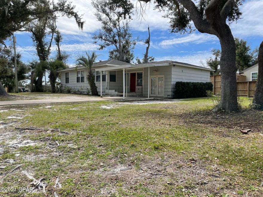 CURRENTLY UNDER CONTRACT, SELLER ACCEPTING BACKUP OFFERS Move in ready Florida Cottage located in the beautiful historic Cove Area of Panama City. Enjoy your morning coffee sitting on your covered front porch with a view of Watson Bayou. Home is close to Bay Medical Center, Tyndall AFB, downtown, restaurants, parks, shopping and of course water activities. Beautiful hardwood floors and freshly painted interior with neutral colors will match any furniture décor. Pet friendly with completely fenced in back yard and sunroom. Covered carport and front porch keeps you dry on those rainy Florida days. Large bonus room that can be entered from the tile foyer or French doors cover by the carport.  Large lot has plenty of space to park your boat or RV.  Greet your neighbors as you enjoy cool evenin Bayou. Covered back porch is a perfect spot for BBQ's and outside dining. All measures are approximant and should be verified if important. Call your favorite Realtor to see this cute cottage in the Cove today.