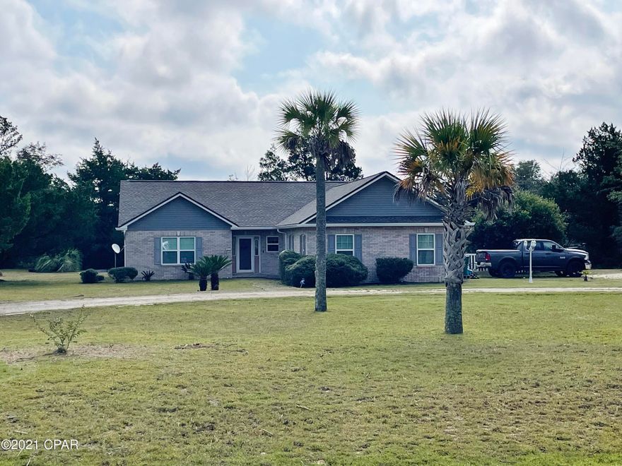 Very privately located in Compass Lake in the Hills is this 3BR/2B, Split bedroom plan, 2008 sq ft home that has been updated with the following: New roof, New vinyl siding, new windows, new doors, new flooring, new paint, appliances replaced a couple of years ago and much more. The kitchen has all the appliances, breakfast bar, center island, pantry and computer desk. There is a spacious family room and then the big Florida room that offers the feeling of outside but staying cool! There is a fenced back yard for pets, a 2 car garage,  the home is wired for a generator and has 8 outside security cameras that are included