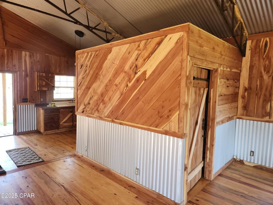 The property is a one bedroom one bathroom cedar trimmed cabin with a large screened in back porch overlooking Equaloxic Creek.  There is a private milled driveway to a boat ramp for the creek and sits on 1.6 acres.  The large RV shed has a milled driveway with water and electric hookups. The separate building has washer and dryer hookups, sink, shower and commode.  Outside of the utility building is a commercial grade cleaning station with a metal pole that has a pulley system for cleaning deer.  Many citrus trees that produce a tremendous amount of oranges and grapefruits are on the land as well.  You will not find another property like this with the closest neighbor being over one mile away.  Don't miss out on your remote slice of heaven!  Broker/Owner.