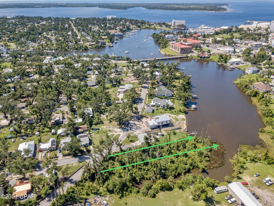 Popular Cove area's Massalina Bayou — deep wooded lot offers tucked-in privacy for your waterfront home.