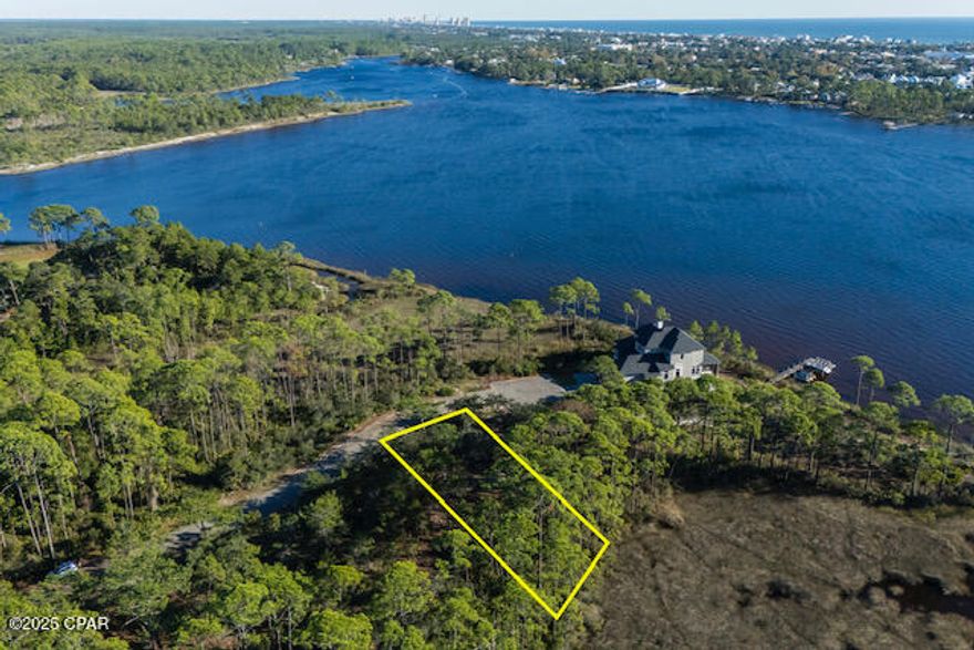Do not miss out on this premium homesite in the Wild Heron community, ideal for those seeking a serene and luxurious lakeside lifestyle. This beautiful homesite will have front, back and south side views of Lake Powell, Florida's largest coastal dune lake. This lot offers privacy under majestic old oaks and captivating water views. Wild Heron boasts a coastal craftsman charm and is home to the renowned Greg Norman's Shark's Tooth Golf Course, with a future course designed by Davis Love III on the way. A Watersound Club membership is necessary to access these elite golf amenities, making this property perfect for golf enthusiasts and nature lovers alike.

Wild Heron provides an exceptional living experience with world-class amenities, including 24-hour security, a gated entrance, a lakeside grill and fire pit, a community swimming pool, fitness center, and nature trails. The Wild Heron community is conveniently located on the west end of Panama City Beach, which is just minutes from Pier Park and the renowned 30A area. Offering a tranquil, family-friendly atmosphere, Wild Heron prohibits short-term rentals, ensuring a peaceful and private environment for its residents.