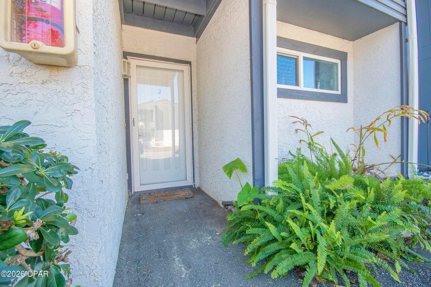 This condo is ideally located on the east end of PCB, conveniently close to the beach and St. Andrews Park. Enjoy easy access to nearby outdoor activities, restaurants, and shopping. This small, cozy complex offers a quiet setting with a community pool and a relaxed coastal atmosphere. The unit is ideally situated on the first floor and features a desirable split-bedroom plan. Both bedrooms include walk in closets, with the primary bedroom offering a private en-suite bath. The secondary bath is accessible from both the guest bedroom and the open living area, providing added convenience. Sliding glass doors offer peaceful views of the surrounding green space, enhancing the bright and open feel of the living area and guest room. The kitchen includes a breakfast bar and pantry with an open view of the living area, creating a welcoming and functional space. A dedicated laundry area with washer and dryer adds to the convenience. It is only a few steps from the pool for a day of relaxation. With endless potential, this unit is perfect for effortless living, a personalized revocation, or short-term and long-term investment opportunity. Motivated sellers have priced this unit for a quick sale. Don't miss out on this opportunity. Pet friendly community. New hot water heater with expansion tank and garbage disposal. Seller will replaced dishwasher prior to closing. All measurements are approximate. If important, please self-measure. Roof and gutters were replaced approximately 5 years ago.