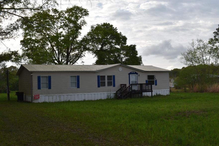 If you are looking for a nice big home with acreage look no farther!!! This 3BR/2BA DWMH has lots of extras including. newer metal roof, (since Hurricane Michael) , painted ceilings, built in entertain center, walk in closets, oversized kitchen/separate dining room, oversized living room, oversized master bedroom/masterbath with 2 vanities, garden tub with a separate shower. Extras on the property includes 10 acres, pond, RV hookup/concrete slab, two older mobilehomes with titles that with a little TLC can make great rentals/family homes, with a septic tank between them. In the past all mobile homes had separate addresses and could possibly be done again.